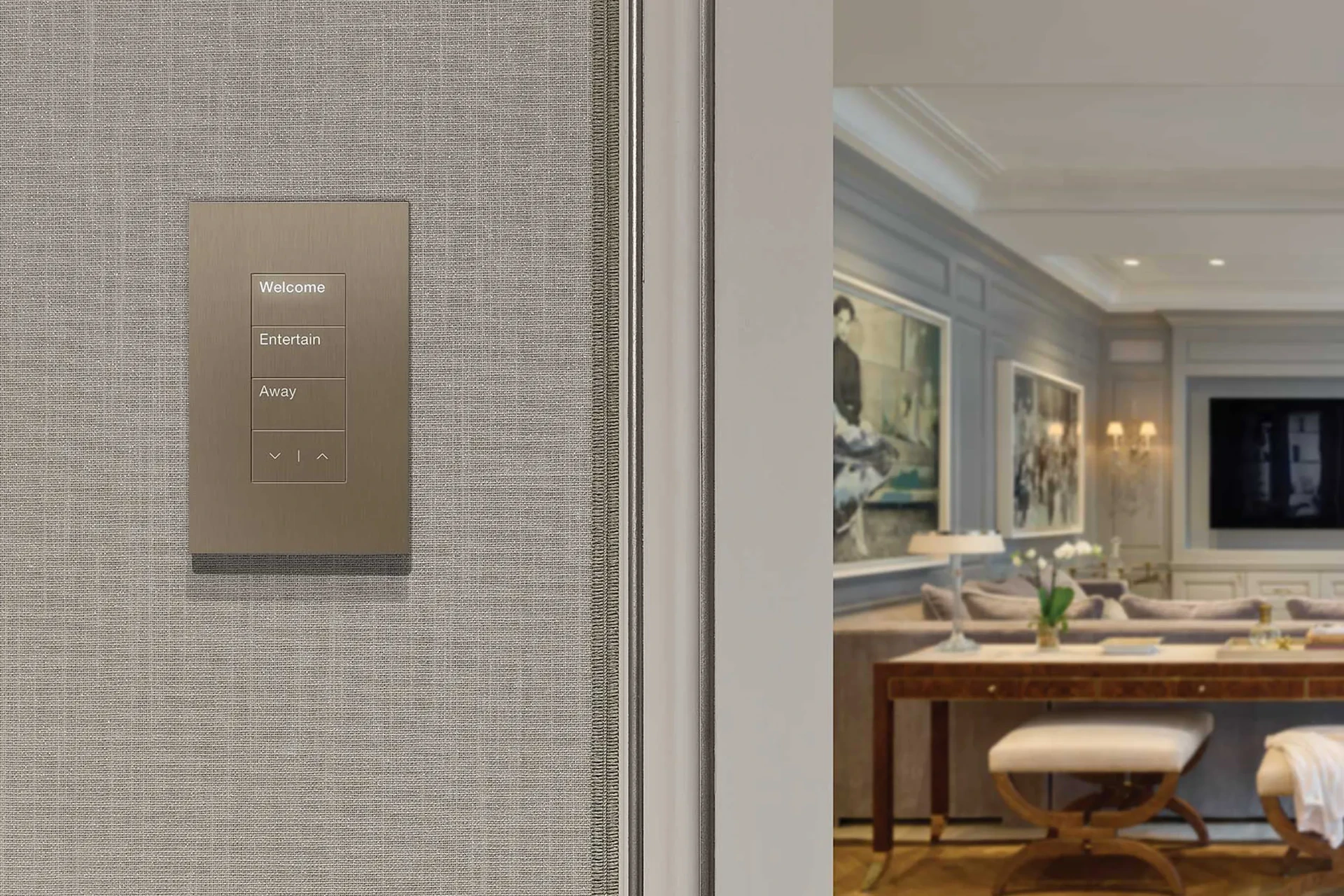 Engraved lighting control keypad glowing on a hallway wall