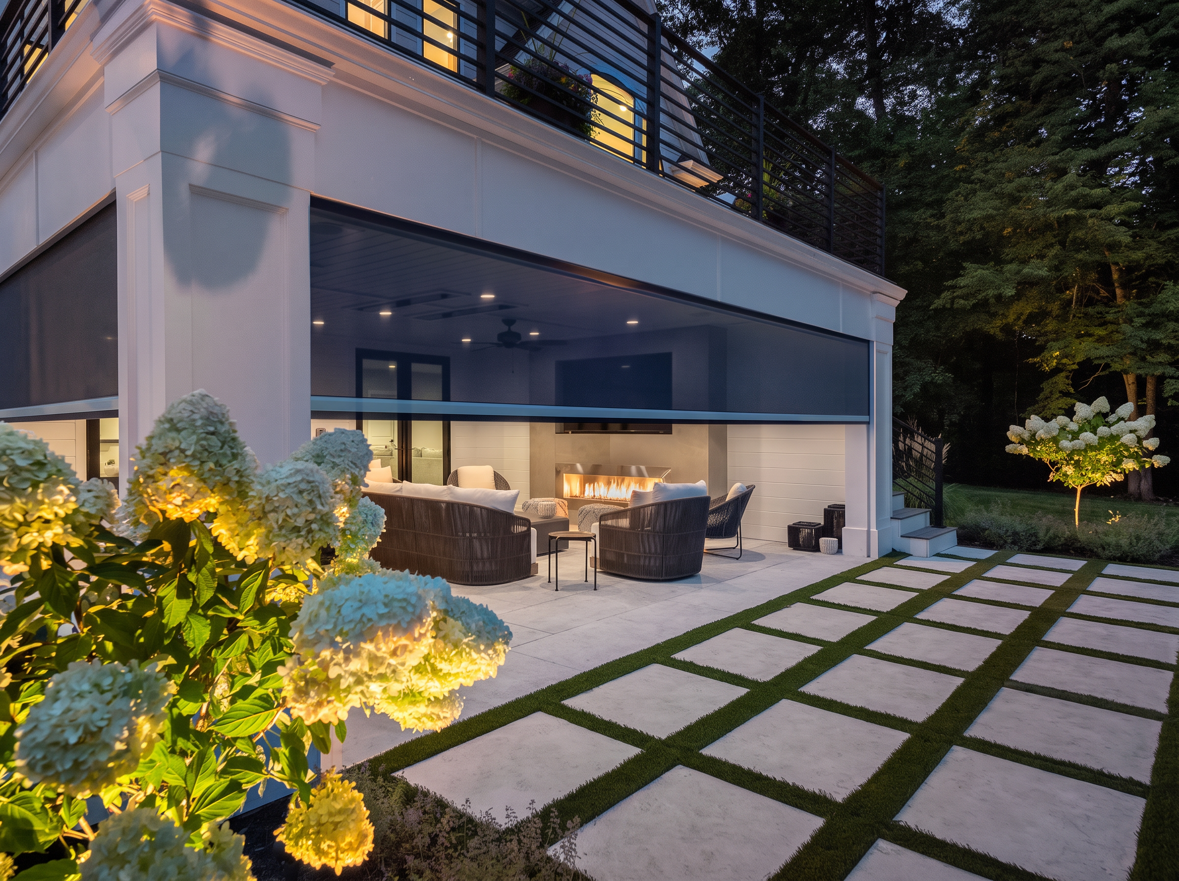 Covered stone patio with lounge seating and a motorized retractable screen lowered along the opening